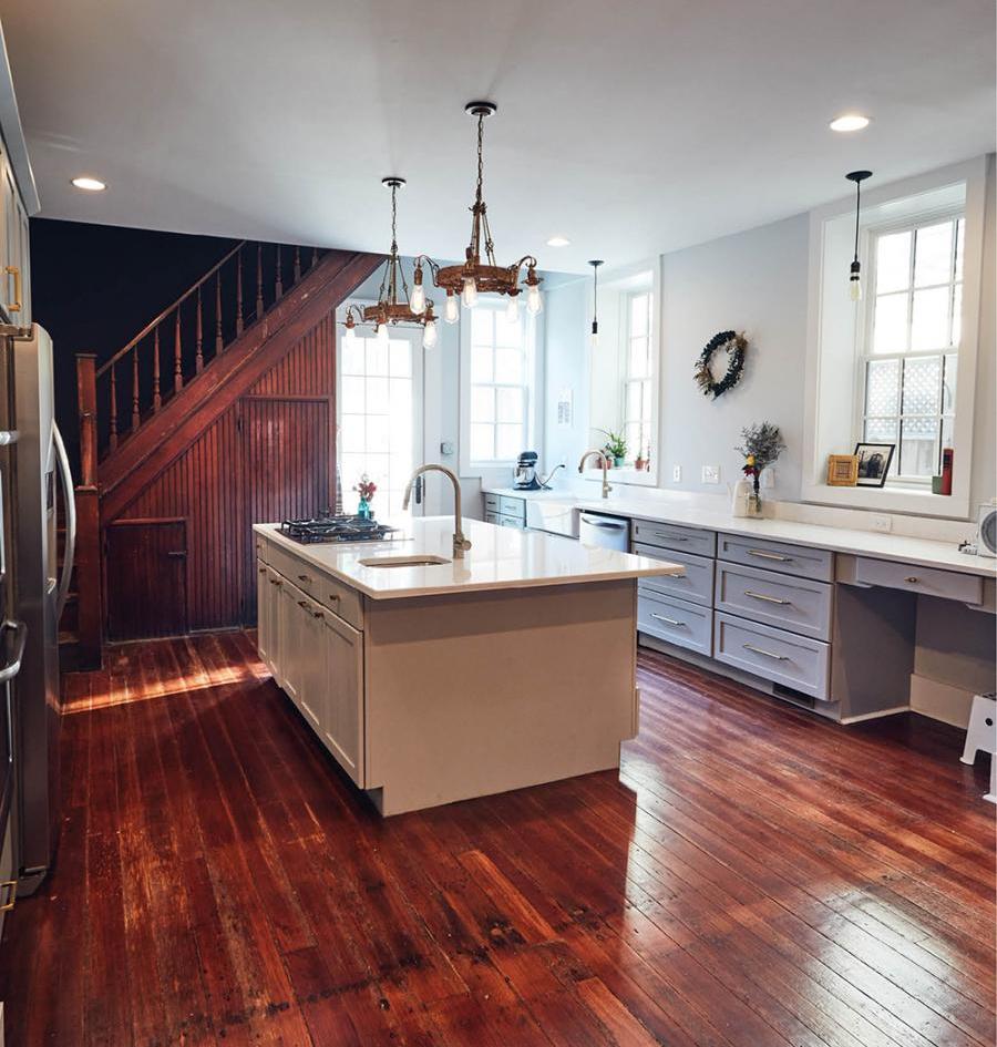 The Von Allmens designed the spacious kitchen pairing original hardwood flooring with new quartz countertops and cabinetry from Profiles in Design.