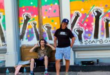Meet One of the Artists Behind the Powerful GOODS Storefront Mural